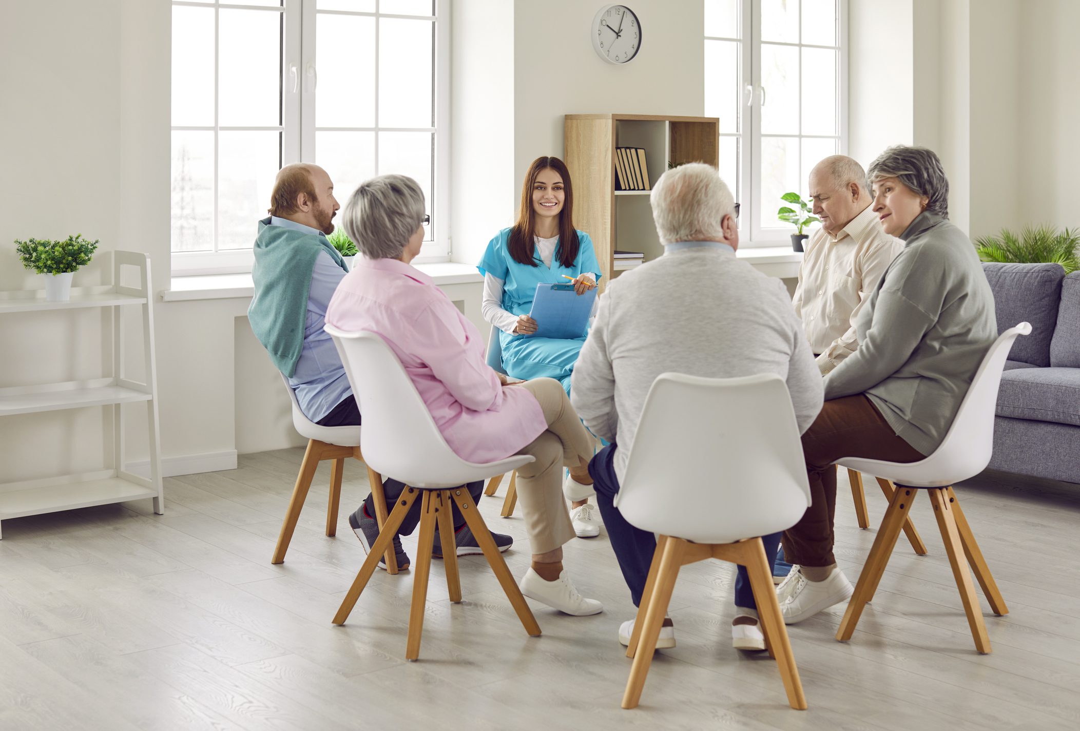 Group therapy session with elderly participants.